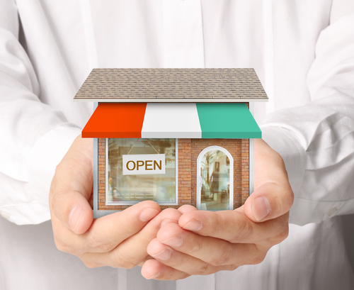 Hands holding model house